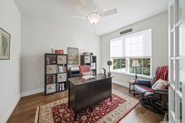 home office featuring dark hardwood / wood-style flooring and ceiling fan