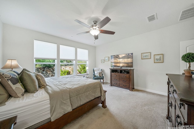 bedroom with ceiling fan and light colored carpet