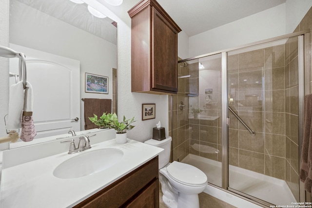 bathroom with walk in shower, vanity, and toilet