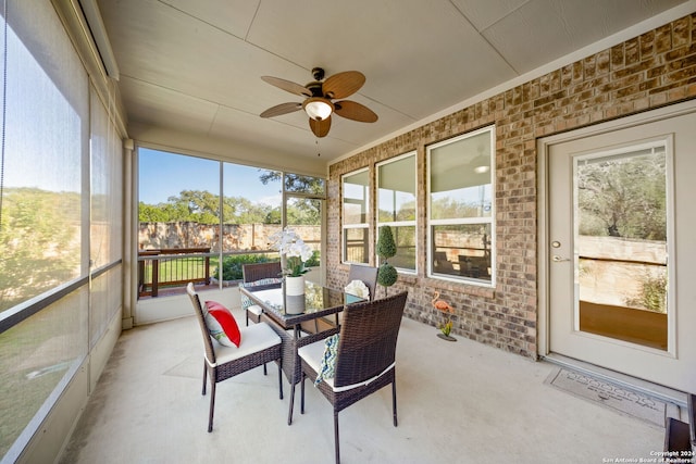 sunroom featuring ceiling fan