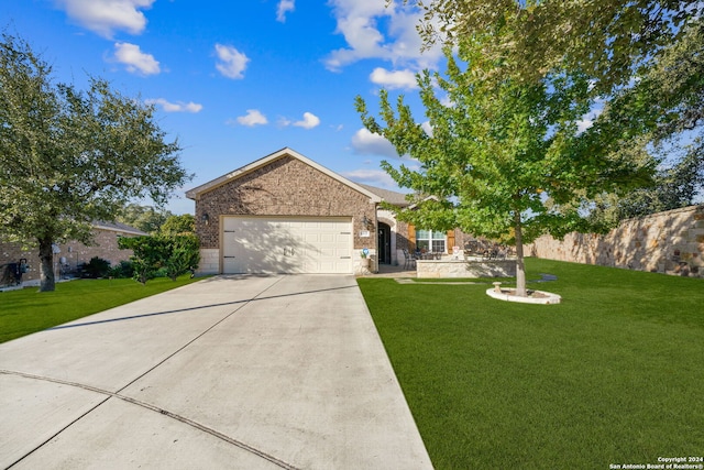 view of front of property with a front yard and a garage