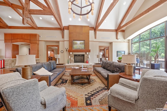 living room with high vaulted ceiling, a fireplace, a notable chandelier, and beamed ceiling