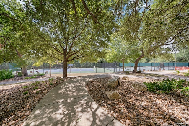 surrounding community featuring tennis court