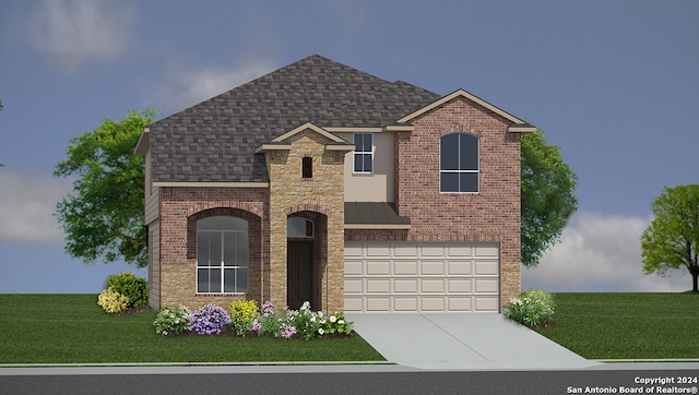 view of front of house with a front yard and a garage