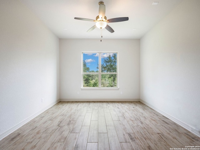 spare room with light wood-type flooring and ceiling fan