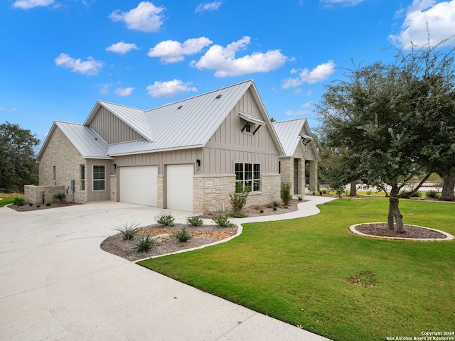 modern farmhouse with a front yard and a garage