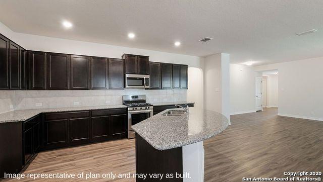 kitchen featuring appliances with stainless steel finishes, light wood-type flooring, a kitchen island with sink, and sink