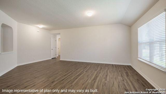 unfurnished room with dark hardwood / wood-style floors and lofted ceiling