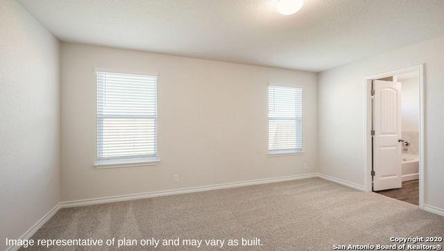 unfurnished bedroom featuring carpet and ensuite bath