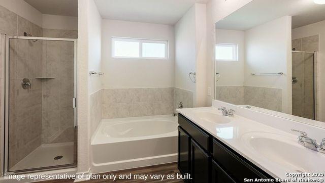 bathroom featuring vanity, independent shower and bath, and hardwood / wood-style flooring