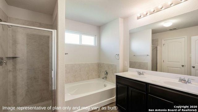 bathroom with vanity and separate shower and tub