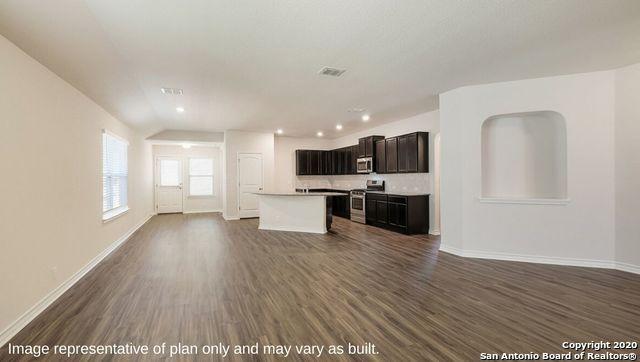 kitchen with appliances with stainless steel finishes, a center island, dark hardwood / wood-style flooring, and vaulted ceiling