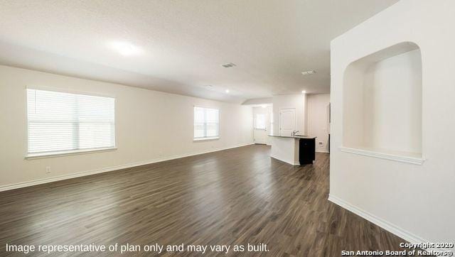 unfurnished room featuring dark wood-type flooring