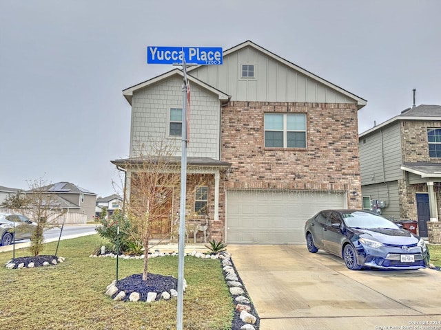 view of front of property with a front lawn and a garage