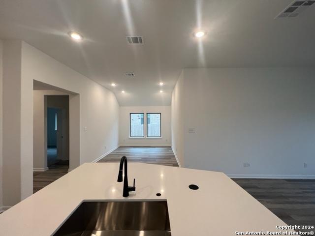 kitchen with recessed lighting, light countertops, dark wood finished floors, and visible vents