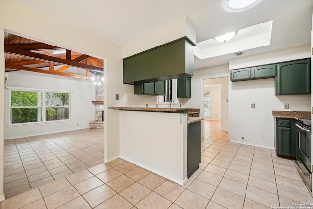 kitchen featuring dark stone counters, green cabinets, light tile patterned floors, stainless steel range oven, and wood ceiling