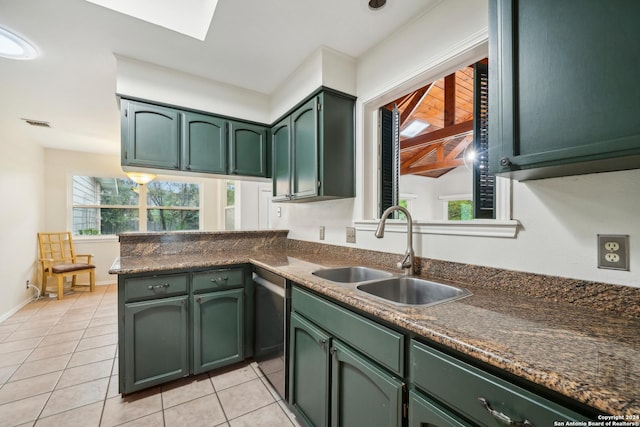 kitchen with green cabinets, light tile patterned flooring, kitchen peninsula, and sink