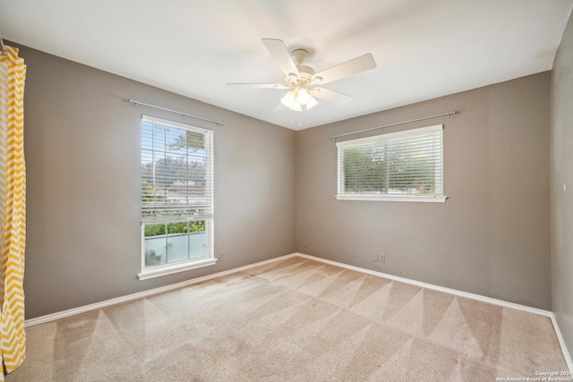 carpeted empty room with ceiling fan