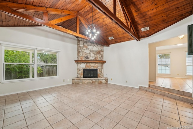 unfurnished living room featuring an inviting chandelier, a stone fireplace, wooden ceiling, and light tile patterned flooring