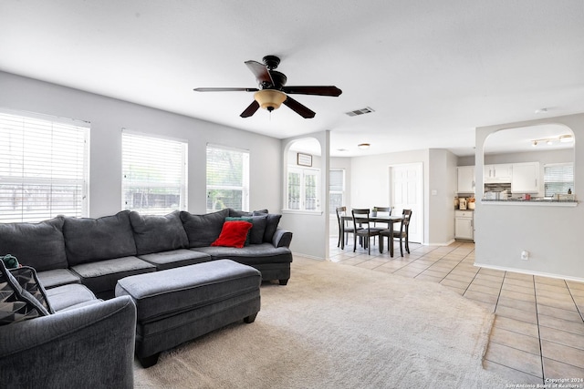 tiled living room featuring ceiling fan