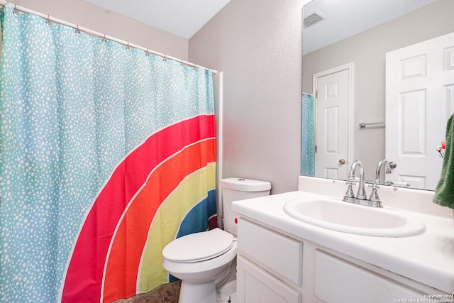 bathroom with vanity, toilet, and walk in shower