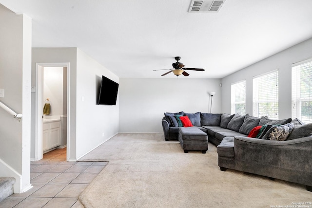 tiled living room with ceiling fan