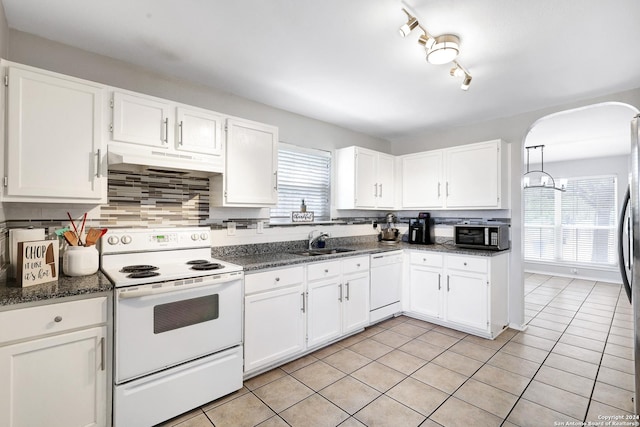 kitchen featuring a healthy amount of sunlight, white cabinetry, and appliances with stainless steel finishes