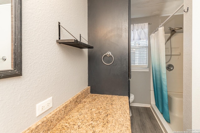 bathroom featuring a shower with curtain, hardwood / wood-style floors, and toilet