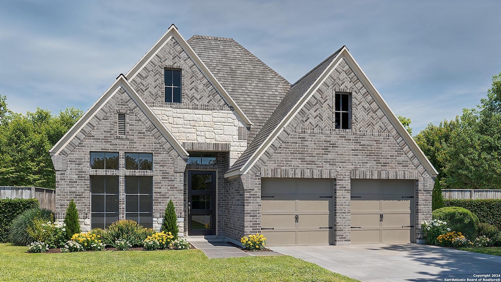 view of front of house with a garage and a front yard