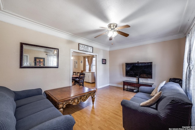 living room featuring crown molding, ceiling fan, and light hardwood / wood-style floors