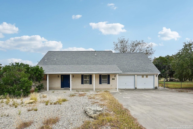 view of front of property with covered porch and a garage