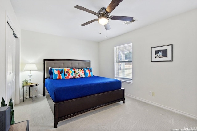 carpeted bedroom featuring a closet and ceiling fan