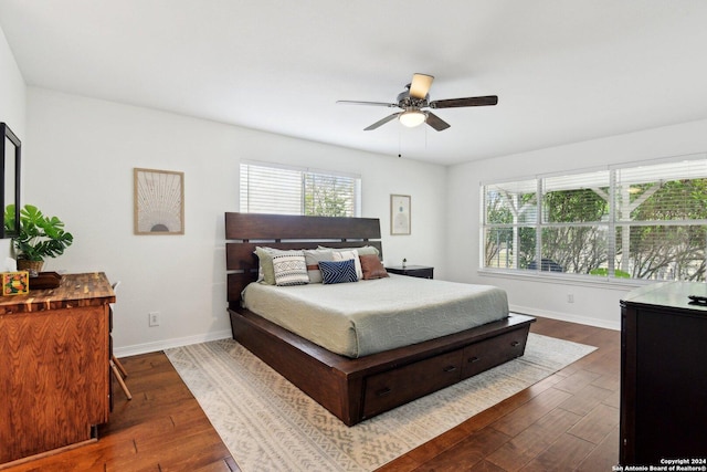 bedroom with ceiling fan and dark wood-type flooring