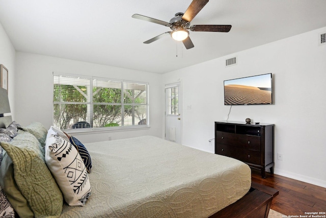 bedroom with ceiling fan and dark hardwood / wood-style floors