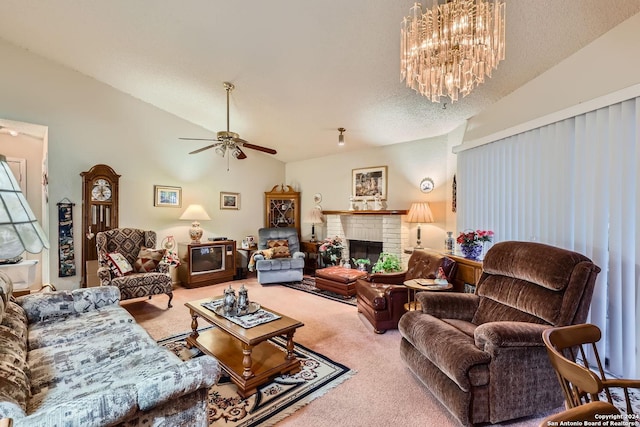 carpeted living room featuring a fireplace, a textured ceiling, vaulted ceiling, and ceiling fan with notable chandelier