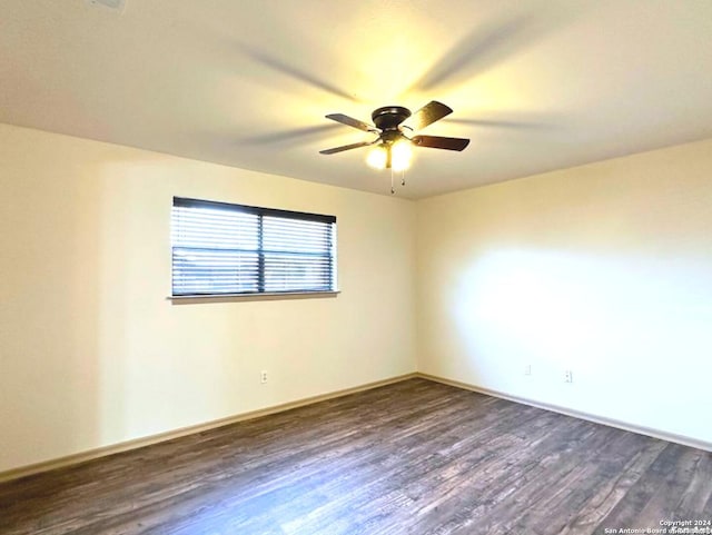 unfurnished room with ceiling fan and dark hardwood / wood-style flooring