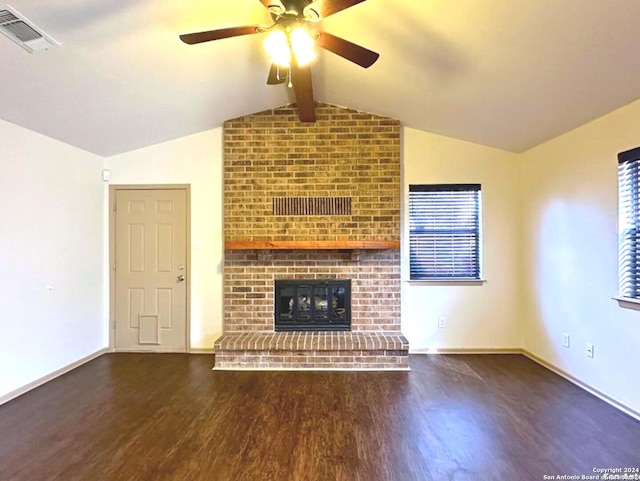 unfurnished living room featuring a fireplace, ceiling fan, dark hardwood / wood-style flooring, and lofted ceiling with beams