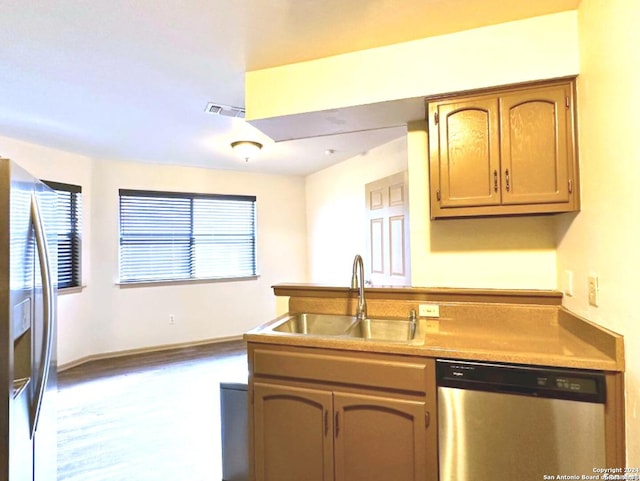 kitchen featuring hardwood / wood-style floors, sink, and appliances with stainless steel finishes