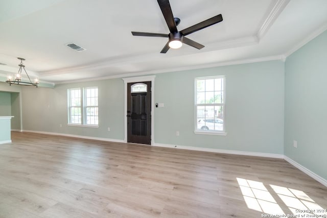 interior space with a healthy amount of sunlight, a tray ceiling, and light hardwood / wood-style flooring