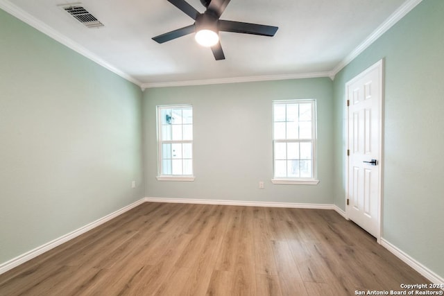 spare room featuring ceiling fan, light wood-type flooring, and crown molding