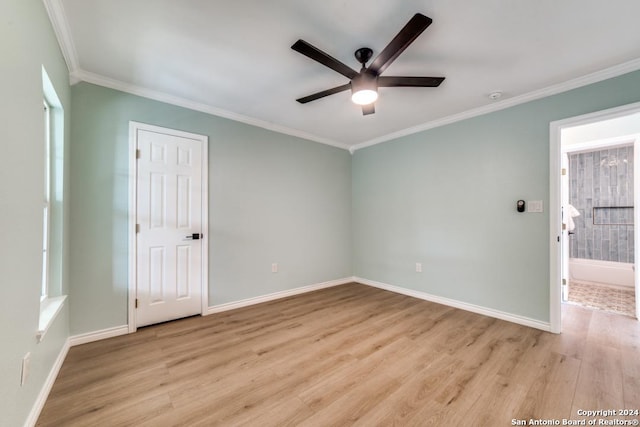 empty room featuring ceiling fan, light hardwood / wood-style floors, and ornamental molding