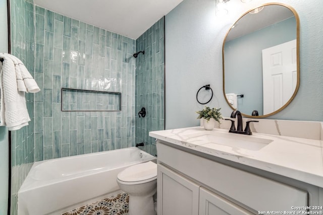 full bathroom with vanity, toilet, and tiled shower / bath