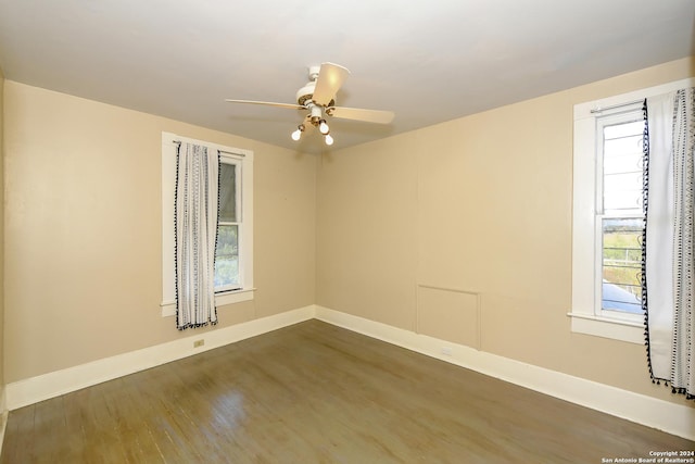 empty room featuring ceiling fan and dark wood-type flooring