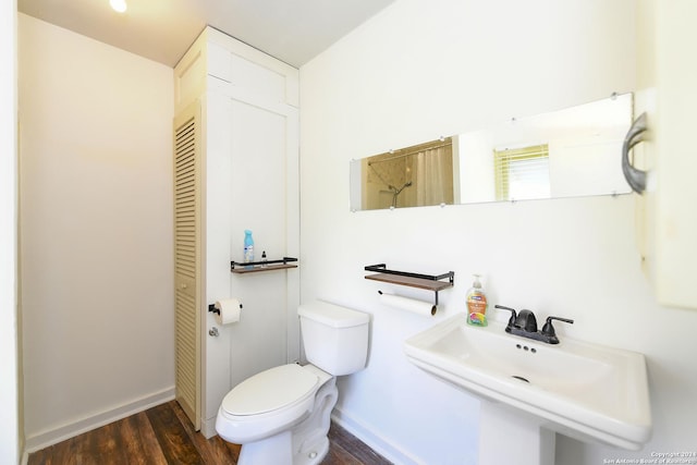 bathroom with sink, hardwood / wood-style floors, and toilet