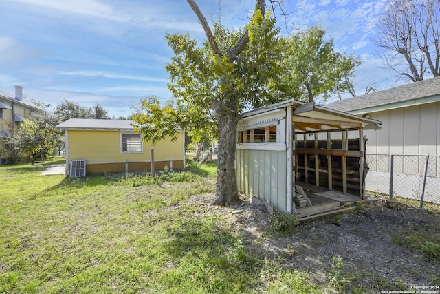 view of yard featuring a shed and central air condition unit