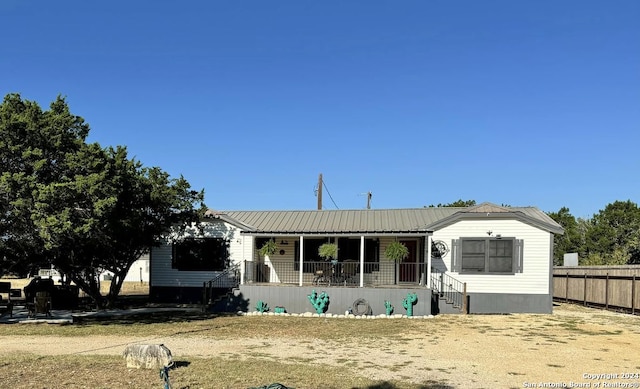 back of house featuring a porch