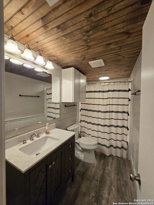 bathroom featuring vanity, toilet, wood-type flooring, and wooden ceiling