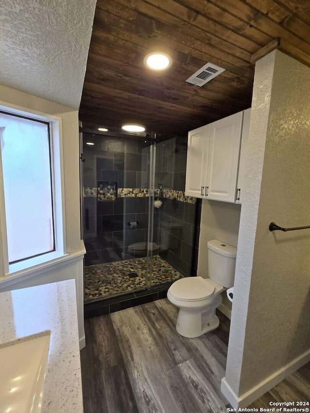 bathroom featuring walk in shower, wood ceiling, vanity, wood-type flooring, and toilet