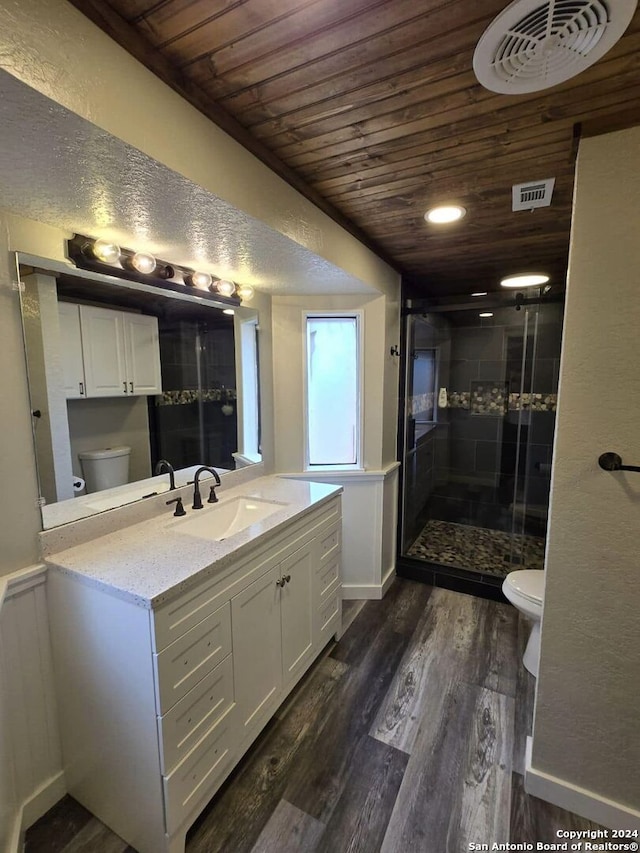 bathroom featuring vanity, toilet, an enclosed shower, wood-type flooring, and wood ceiling