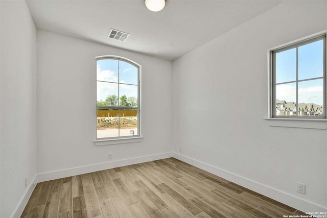 unfurnished room with light hardwood / wood-style flooring